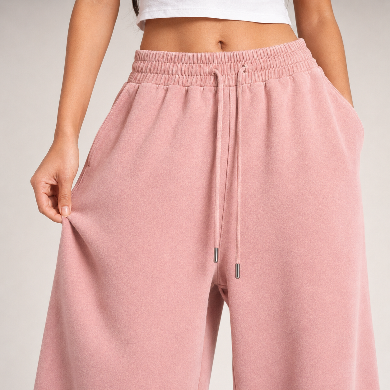 Close-up of dusty pink baggy jogger fabric and waistband