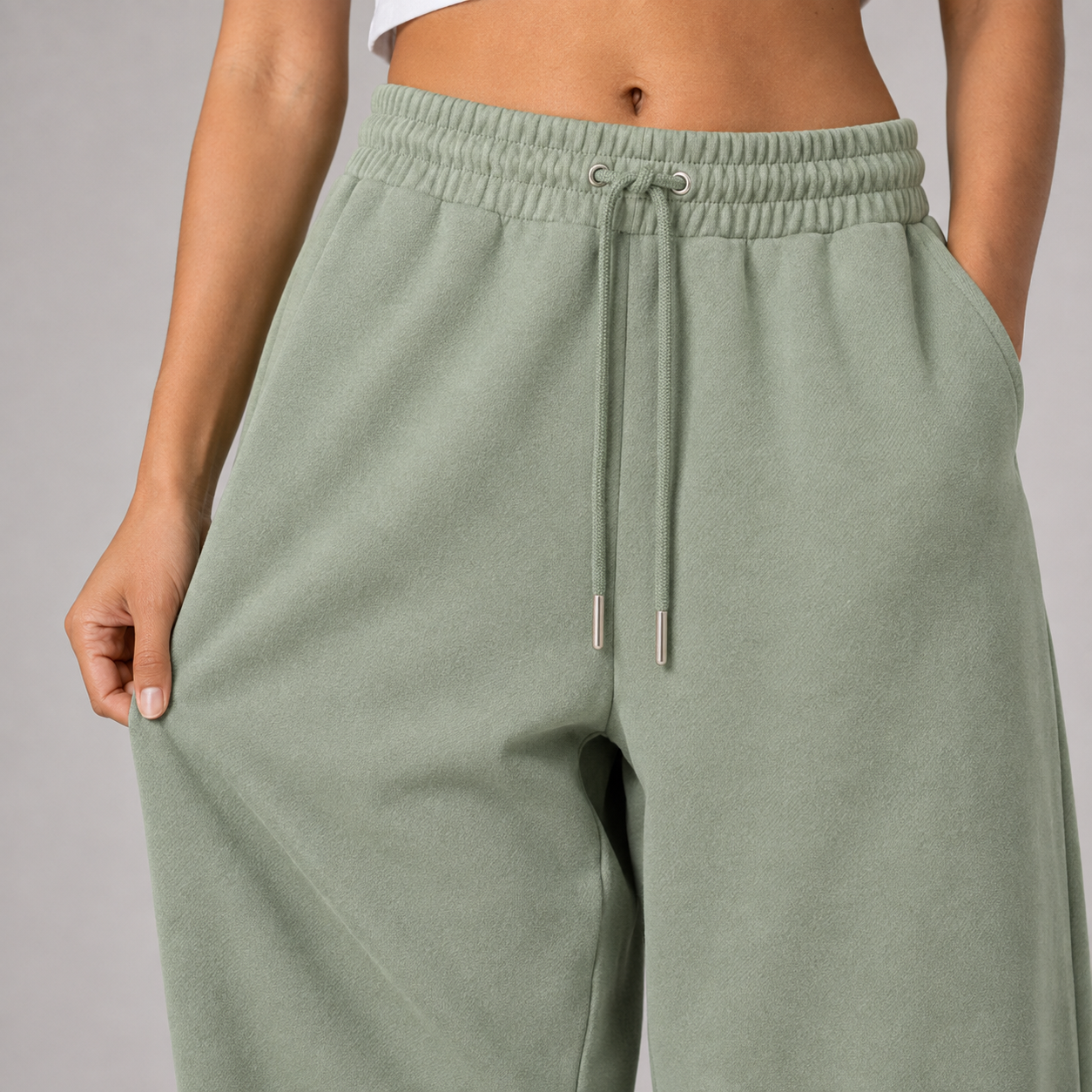 Close-up of sage green baggy jogger fabric and waistband